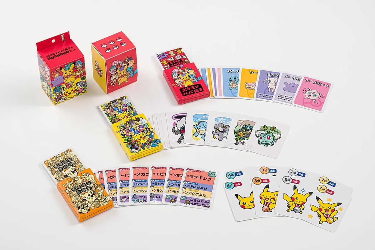 Pokémon-themed trading card set and accessory boxes arranged on a white background, including character cards, a deck, a box, and two decorative dice boxes with colorful Pokémon artwork.
